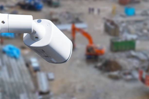 security CCTV camera or surveillance system with construction site on blurry background