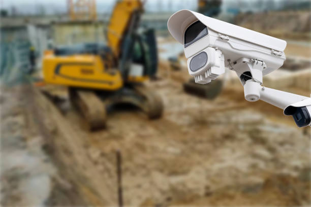 security CCTV camera or surveillance system with construction site on blurry background